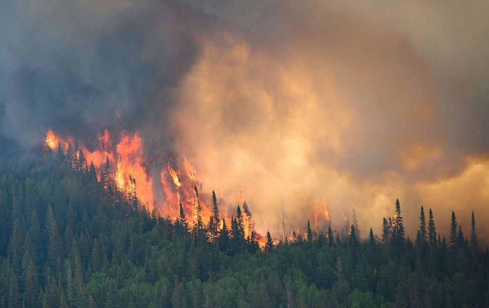 PHOTO: Flames reach up along the edge of a forest fire as seen from a Canadian Forces helicopter surveying the area near Mistissini, Quebec, Canada on June 12, 2023.