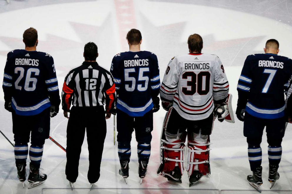 PHOTO: The Winnipeg Jets and the Chicago Blackhawks come together at center ice wearing Broncos on the back of their jerseys for a moment of silence for the Humboldt Broncos bus crash victims before NHL hockey game in Winnipeg, Manitoba, April 7, 2018.