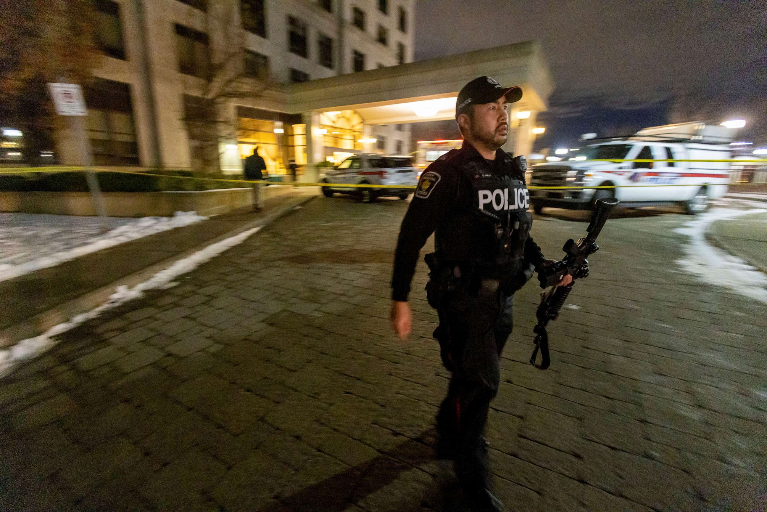 PHOTO: A police officer walks with a weapon after a fatal mass shooting at a condominium building in the Toronto suburb of Vaughan, Ontario, Canada, Dec. 19, 2022.