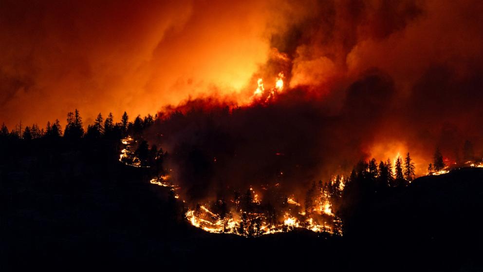 PHOTO: In this Aug. 17, 2023, file photo, the McDougall Creek wildfire burns in the hills West Kelowna, British Columbia, Canada, as seen from Kelowna.