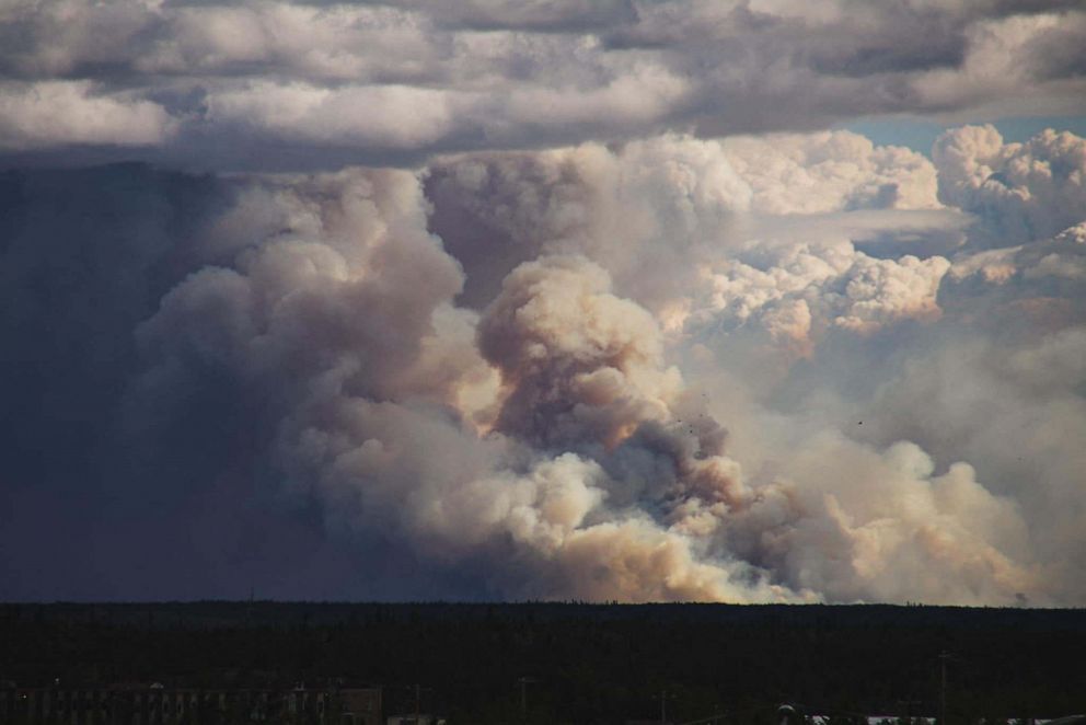 PHOTO: This August 13, 2023, image provided by Sylvia Webster shows smoke rising from wildfires near Yellowknife, Northwest Territories, Canada.