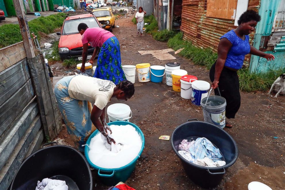 PHOTO: Residents of Masiphumelele informal settlement collect drinking water and wash clothes using water from a communal municipal tap in Cape Town, South Africa, Jan. 30, 2018. 