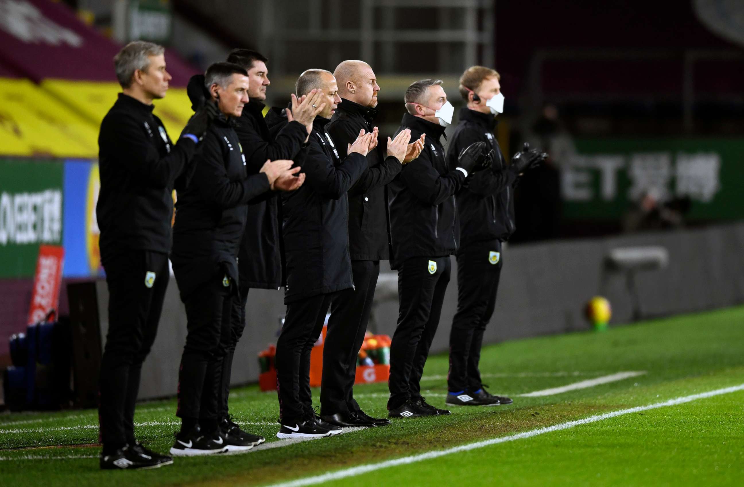 PHOTO: Burnley staff applaud for Captain Sir Tom Moore before the English Premier League soccer match between Burnley and Manchester City at Turf Moor stadium in Burnley, England, Feb. 3, 2021.