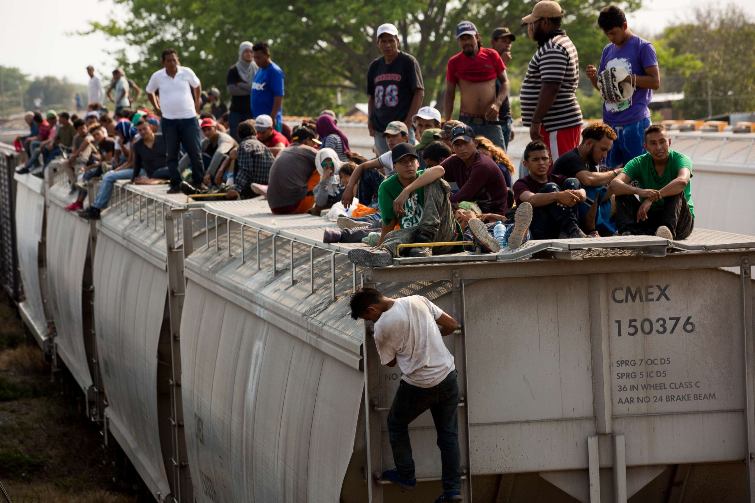 PHOTO:Central American migrants wait on the top of a parked train during their journey toward the US-Mexico border in Ixtepec, Oaxaca state, Mexico, April 23, 2019.