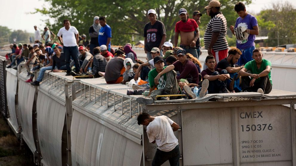 PHOTO:Central American migrants wait on the top of a parked train during their journey toward the US-Mexico border in Ixtepec, Oaxaca state, Mexico, April 23, 2019.