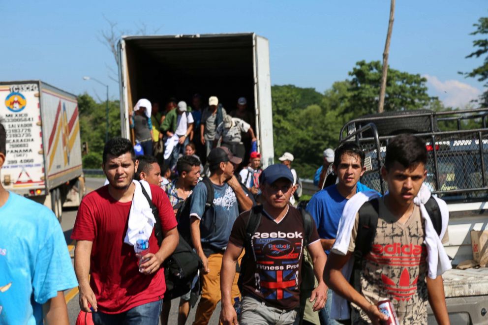 PHOTO: Dozens of migrants appear from the back of a semi truck after filling it to capacity on the way to Tapachula, Mexico.