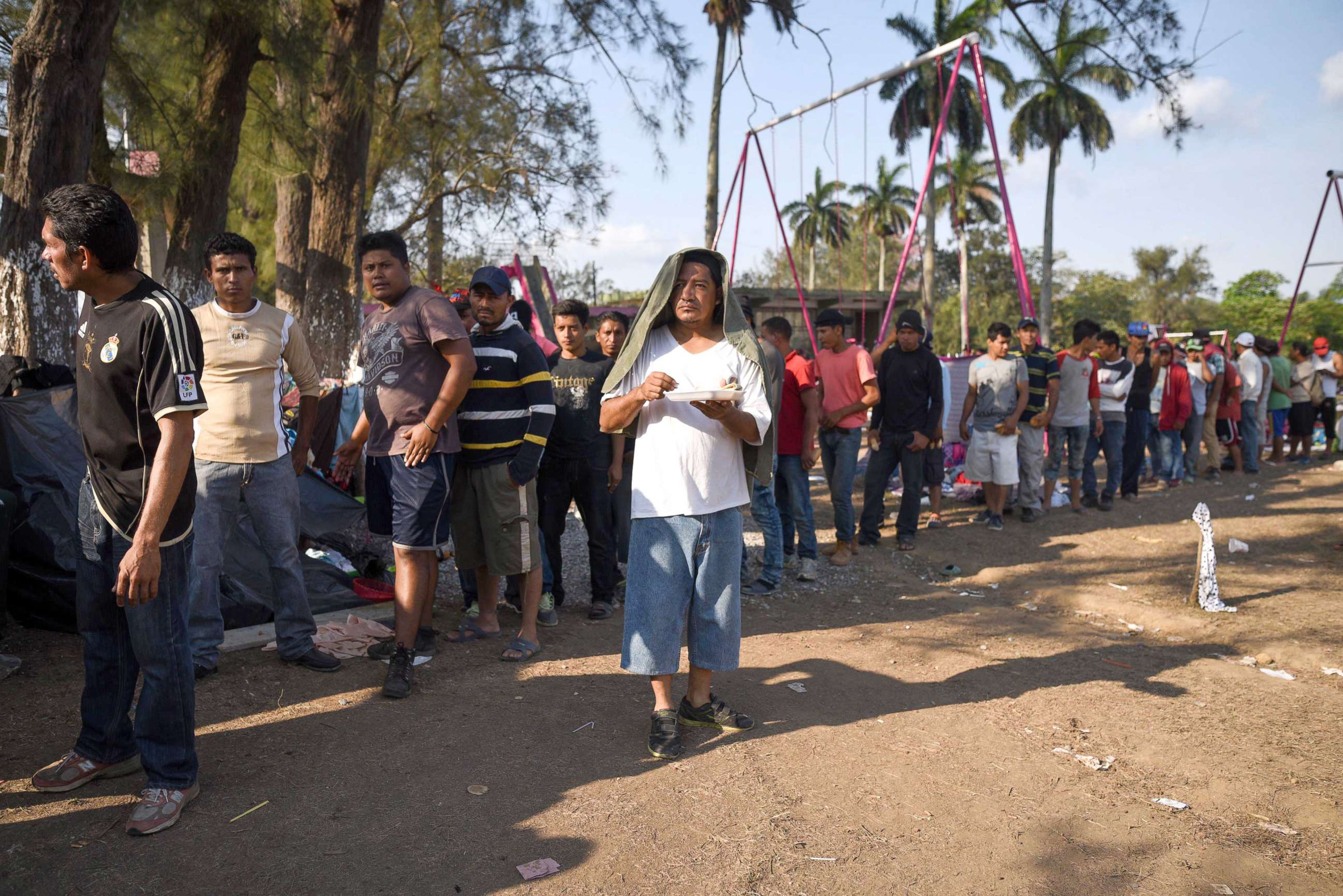PHOTO: Central American migrants taking part in the "Migrant Via Crucis" caravan towards the U.S. queue for breakfast as they camp at a sport complex in Matias Romero, Oaxaca State, Mexico, April 4, 2018.