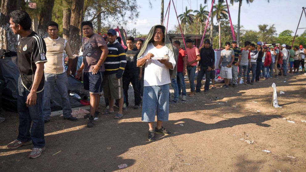 Central American migrants taking part in the "Migrant Via Crucis" caravan towards the U.S. queue for breakfast as they camp at a sport complex in Matias Romero, Oaxaca State, Mexico, April 4, 2018.