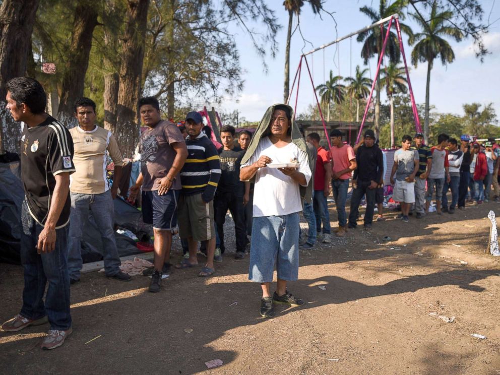 PHOTO: Central American migrants taking part in the Migrant Via Crucis caravan towards the U.S. queue for breakfast as they camp at a sport complex in Matias Romero, Oaxaca State, Mexico, April 4, 2018.