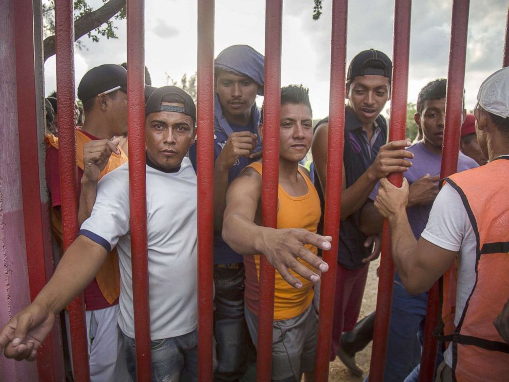 PHOTO: Central American migrants wait for food as they rest in the town of Nicolas Romero, in the state of Oaxaca, Mexico, April 3, 2018.