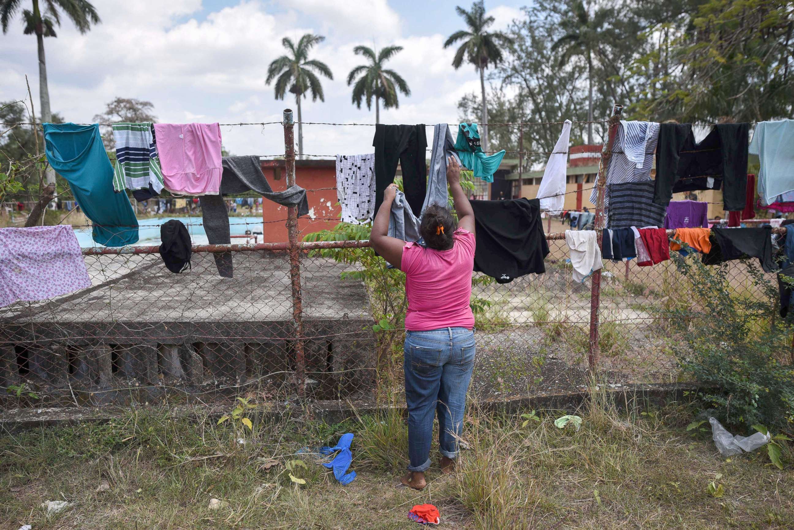 PHOTO: A Central American migrant taking part in a caravan called "Migrant Via Crucis" towards the U.S. hangs clothes to dry at a sports field in Matias Romero, Oaxaca State, Mexico, April 3, 2018.