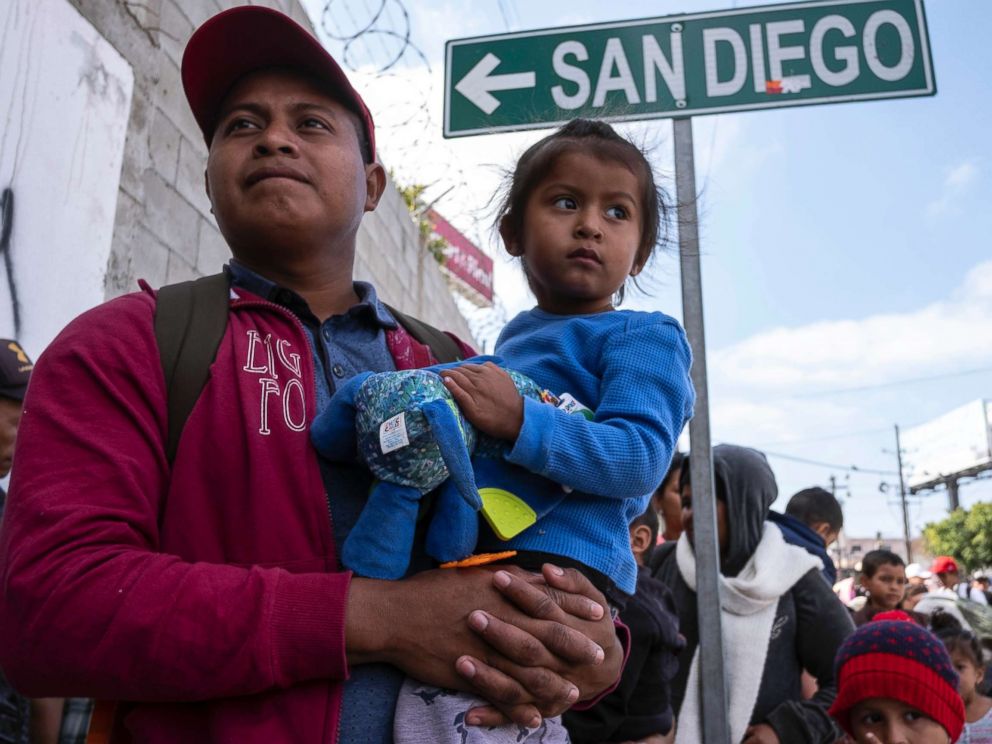 PHOTO: Central American migrants travelling in the Migrant Via Crucis caravan wait outside the Padre Chavas kitchen soup for breakfast and legal counseling, in Tijuana, Baja California State, Mexico, on April 27, 2018.