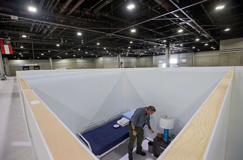 PHOTO: Georgia Emergency Management Agency employees Mike Engleking inspects a room at a 120-bed Alternate Care Facility for coronavirus patients, inside the Georgia World Congress Center in Atlanta, July 24, 2020.