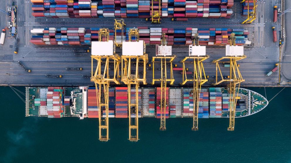 PHOTO: A container ship in harbor with crane.