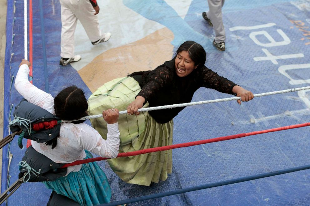 PHOTO: Bolivian Aymara wrestler "Carmen Rosa" battles with her cholita opponent in a popular sports gym in La Paz, May 23, 2010.