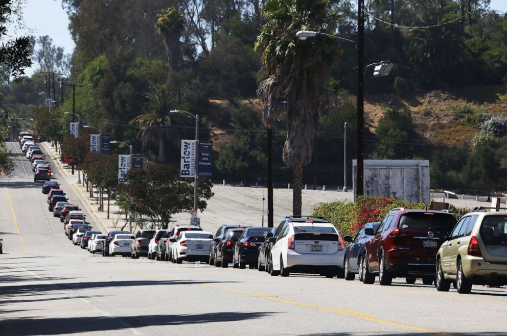 PHOTO: Motorists wait in line to enter the COVID-19 testing center at Dodger Stadium in Los Angeles, July 08, 2020.