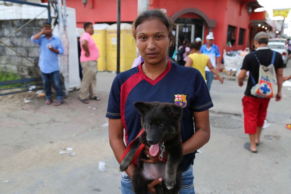 PHOTO: Kimberley Olivares, 20, said she brought her 3-month old puppy with her on the caravan from San Pedro Sula, Honduras.