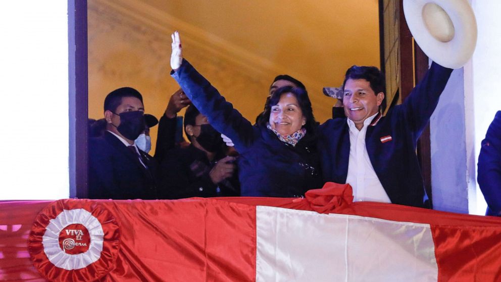 PHOTO: Newly elected president of Peru, Pedro Castillo, waves supporters with his running mate Dina Boluarte, from the campaign headquarters, July 19, 2021, in Lima, Peru.