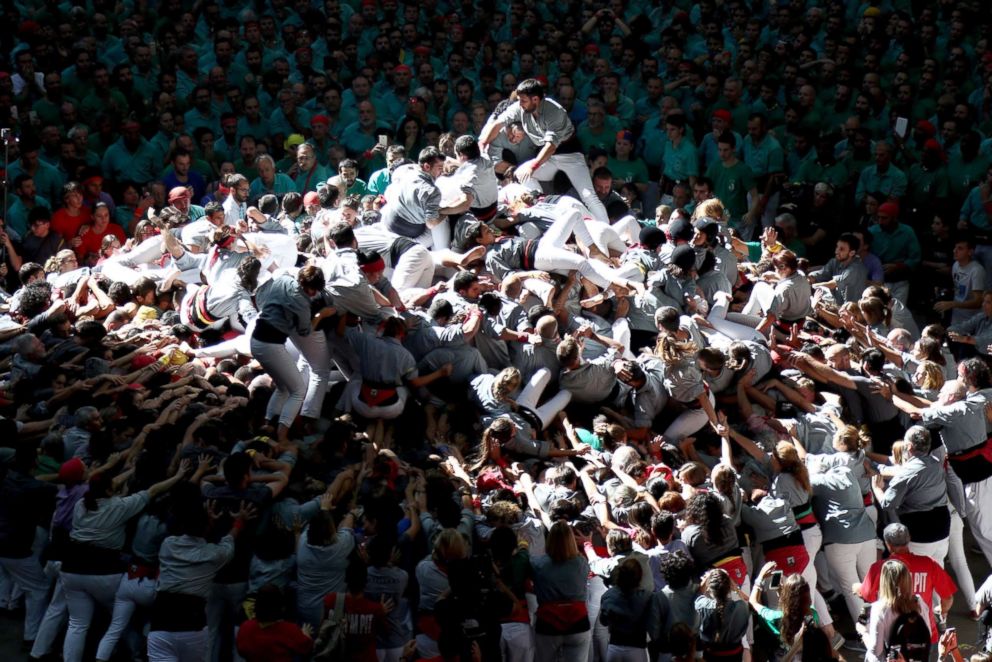 PHOTO: Members of Castellers de Sants fall down as they built a human tower during the 27th Tarragona Competition, Oct. 07, 2018, in Tarragona, Spain.