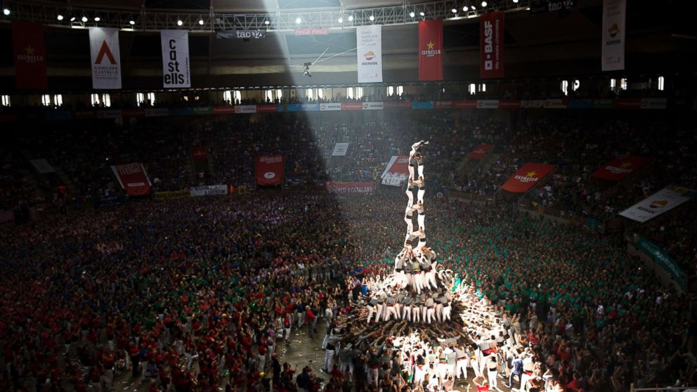 PHOTO: Members of "Castellers de Sants" complete their human tower during the 27th Human Tower Competition in Tarragona, Spain, Oct. 7, 2018.