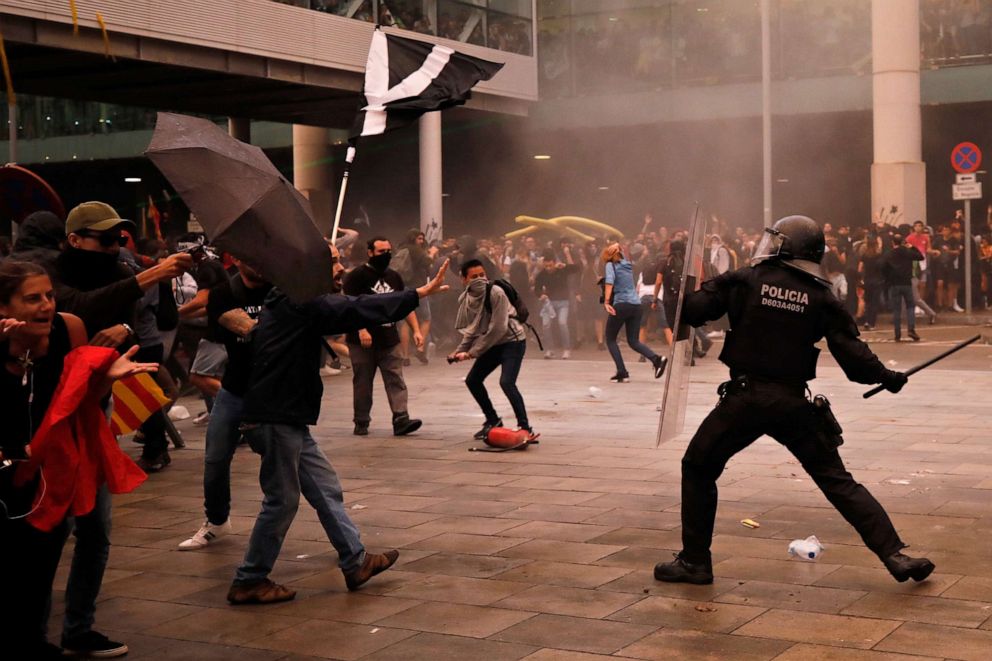 PHOTO: Riot policemen clash with protestors outside El Prat airport in Barcelona, Spain, Monday, Oct. 14, 2019.