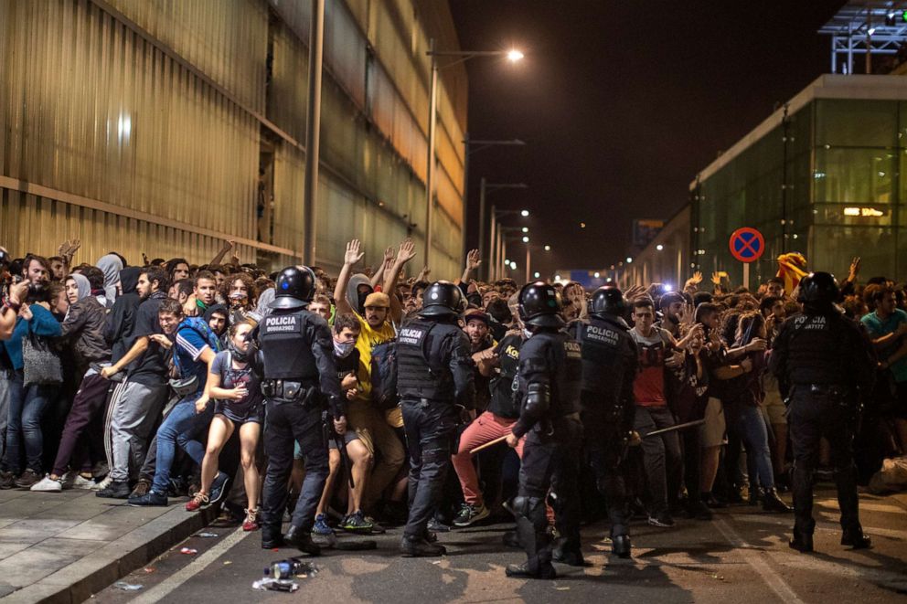 Police charge against demonstrators during clashes outside El Prat airport in Barcelona, Oct. 14, 2019. 