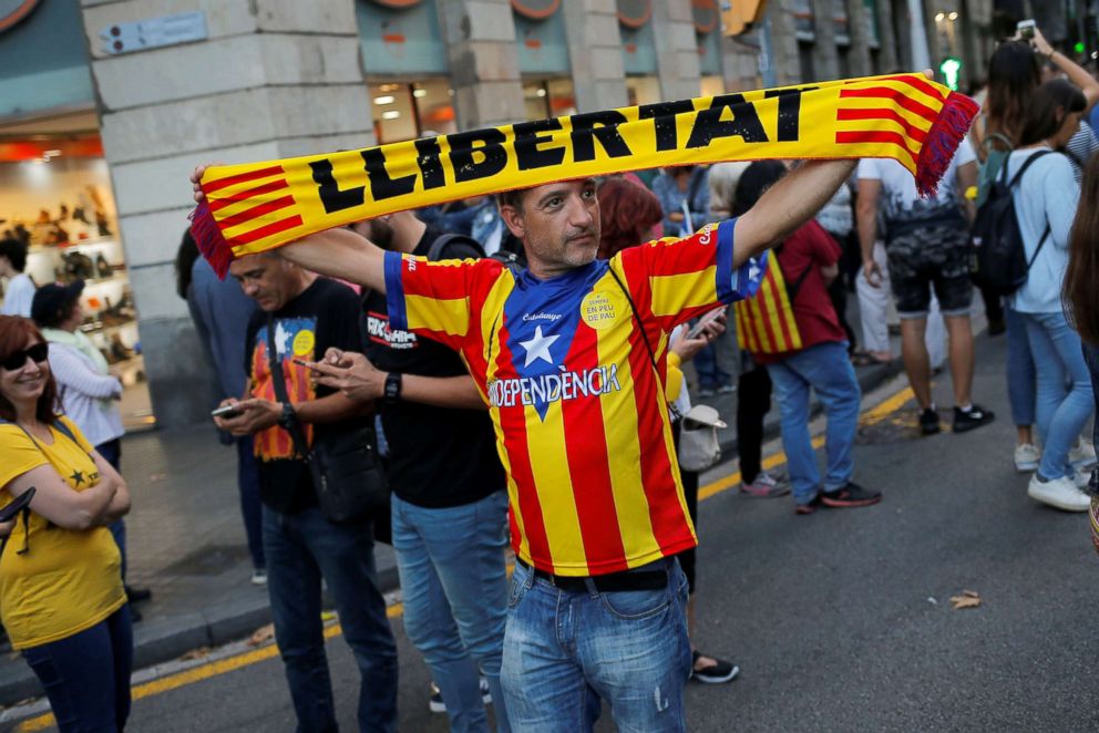 PHOTO: A demonstrator holds up a banner reading "Freedom"  during a demonstration on the first anniversary of Catalonia's banned referendum on independence in Barcelona, Spain, Oct. 1, 2018.