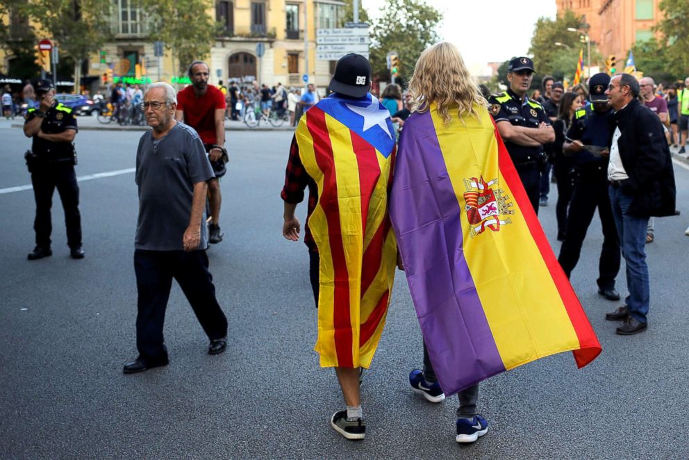 PHOTO: Protestors wear flags during a demonstration on the first anniversary of Catalonia's banned referendum on indpendance in Barcelona, Spain, Oct. 1, 2018.