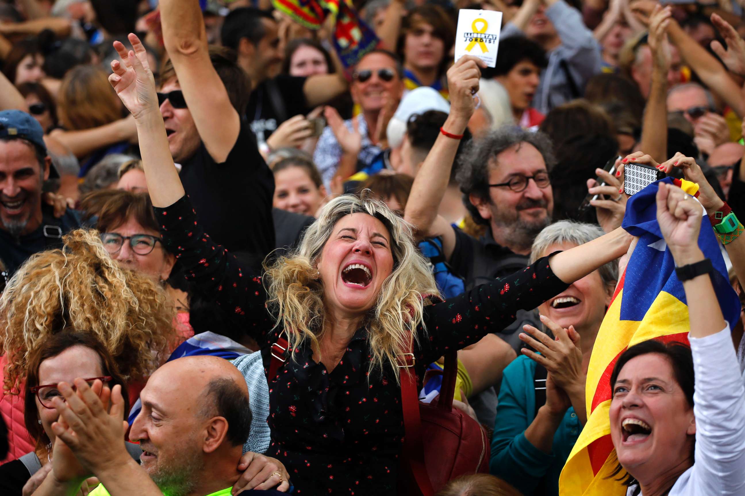 PHOTO: Maria Salut, center, reacts as they celebrate the unilateral declaration of independence of Catalonia outside the Catalan Parliament, in Barcelona, Spain, Oct. 27, 2017.  