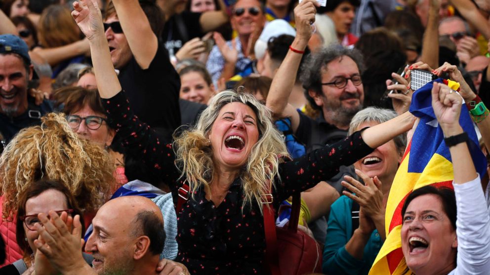 Maria Salut, center, reacts as they celebrate the unilateral declaration of independence of Catalonia outside the Catalan Parliament, in Barcelona, Spain, Oct. 27, 2017. Catalonias' regional Parliament passed a motion Friday to establish an independent Catalan Republic.