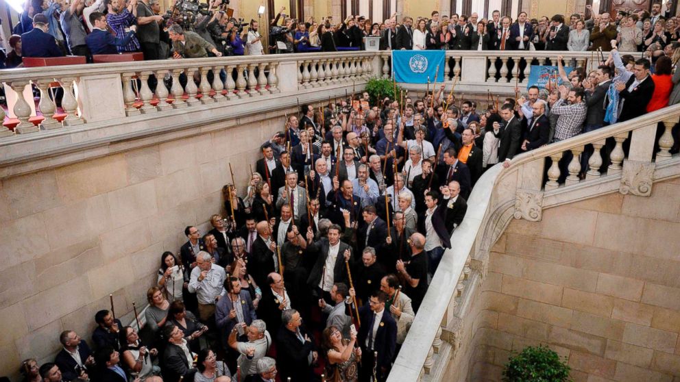 Catalan pro-independence mayors raise their batons after a session of the Catalan parliament in Barcelona, Spain, Oct. 27, 2017. Catalonia's parliament voted to declare independence from Spain with 70 votes in favor, 10 against and two abstentions, with Catalan opposition MPs walking out of the 135-seat chamber before the vote in protest.