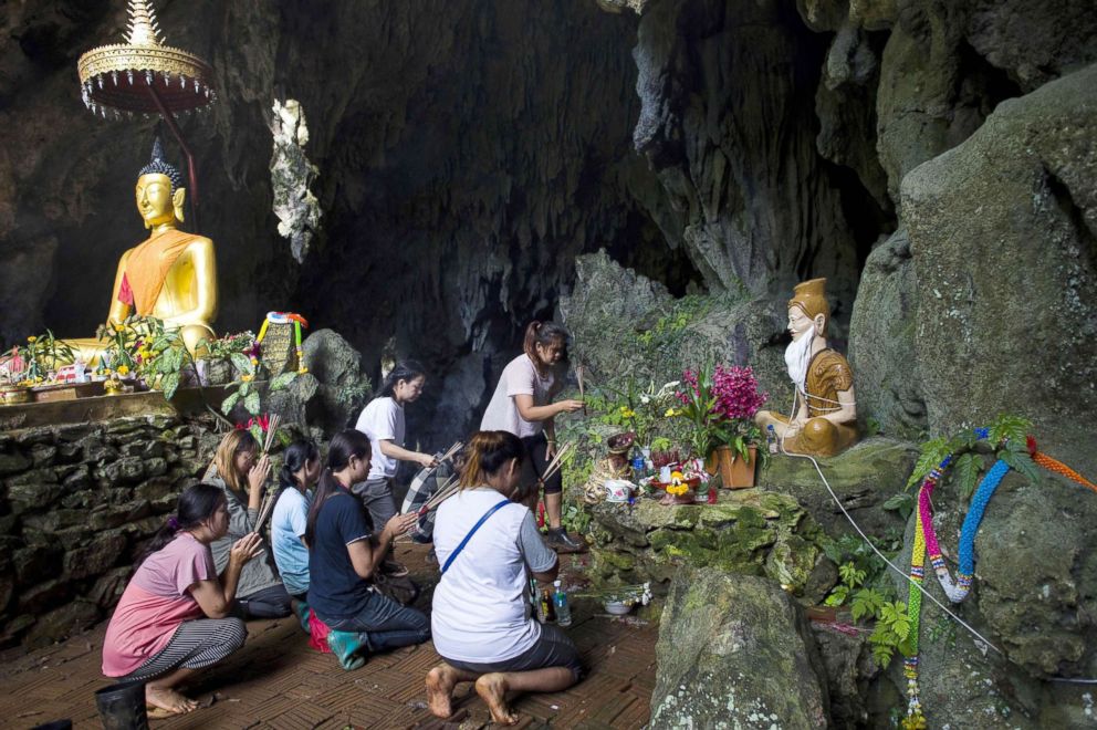 PHOTO: Family members pray before a shrine in Tham Luang cave area as operations continue for the 12 boys and their coach trapped at the cave at Khun Nam Nang Non Forest Park in the Mae Sai district of Chiang Rai province, July 5, 2018.