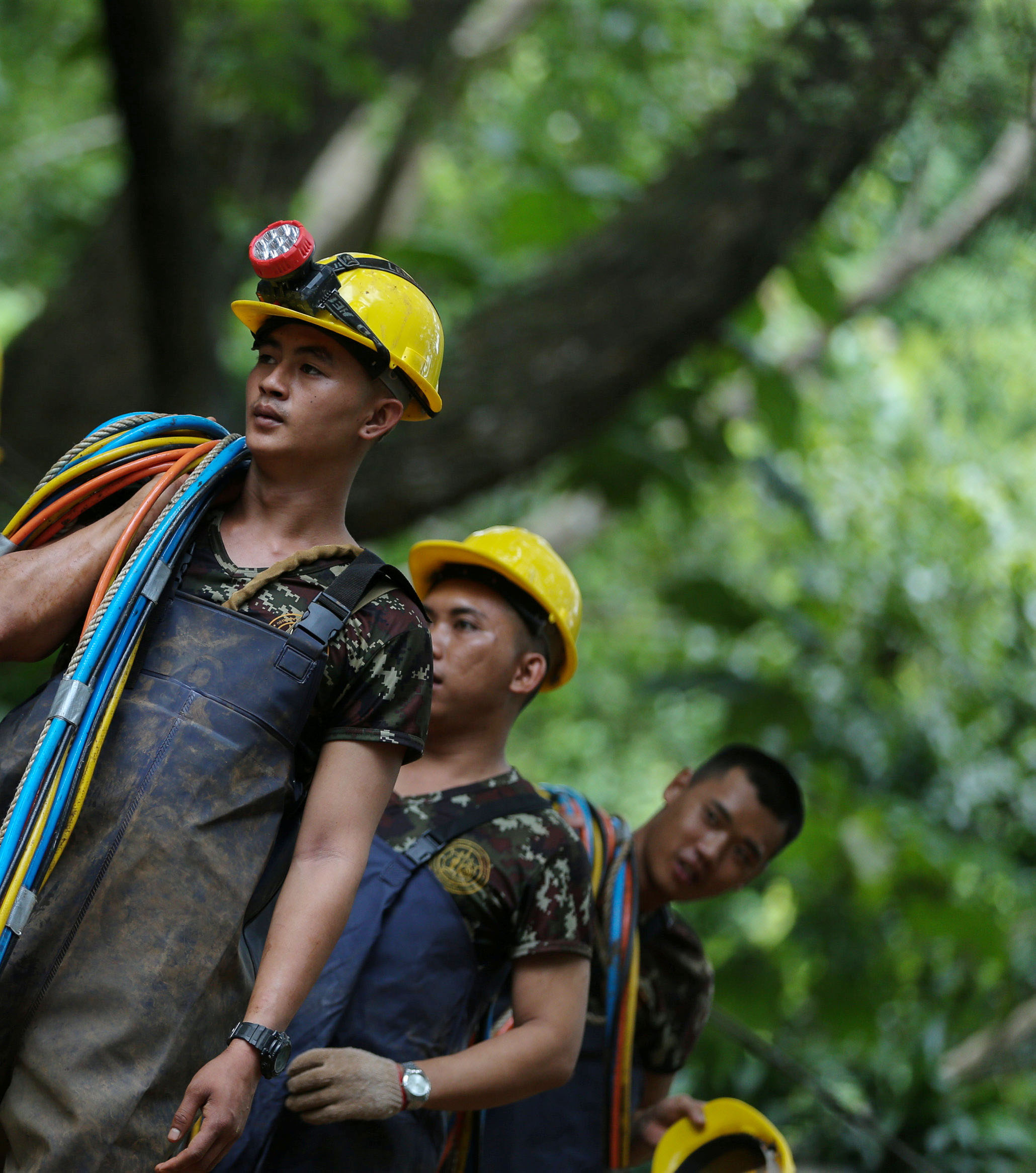 PHOTO: Military personnel carries surface supply diving cables out from the Tham Luang Nang Non cave in the northern province of Chiang Rai, Thailand, July 5, 2018.