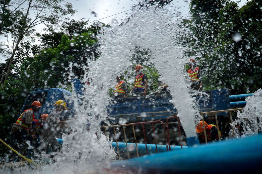 PHOTO: Rescue workers work next to water pumped out of Tham Luang cave complex, in the northern province of Chiang Rai, Thailand, July 5, 2018.