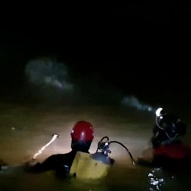 Rescuers said they are contending with low visibility inside the cave and near-freezing water temperatures.