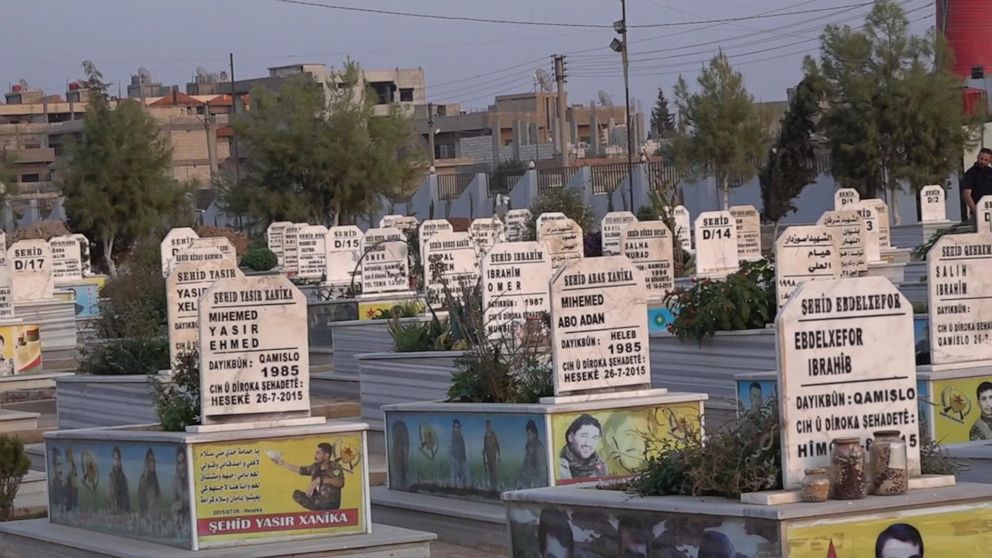 PHOTO: Naila and Simko showed ABC News their sister's grave on the edge of al-Malikiyah, which is marked "Sehid," meaning martyr. In this cemetery, every single tombstone, marking the final resting place of volunteers like Bawer, is marked the same.
