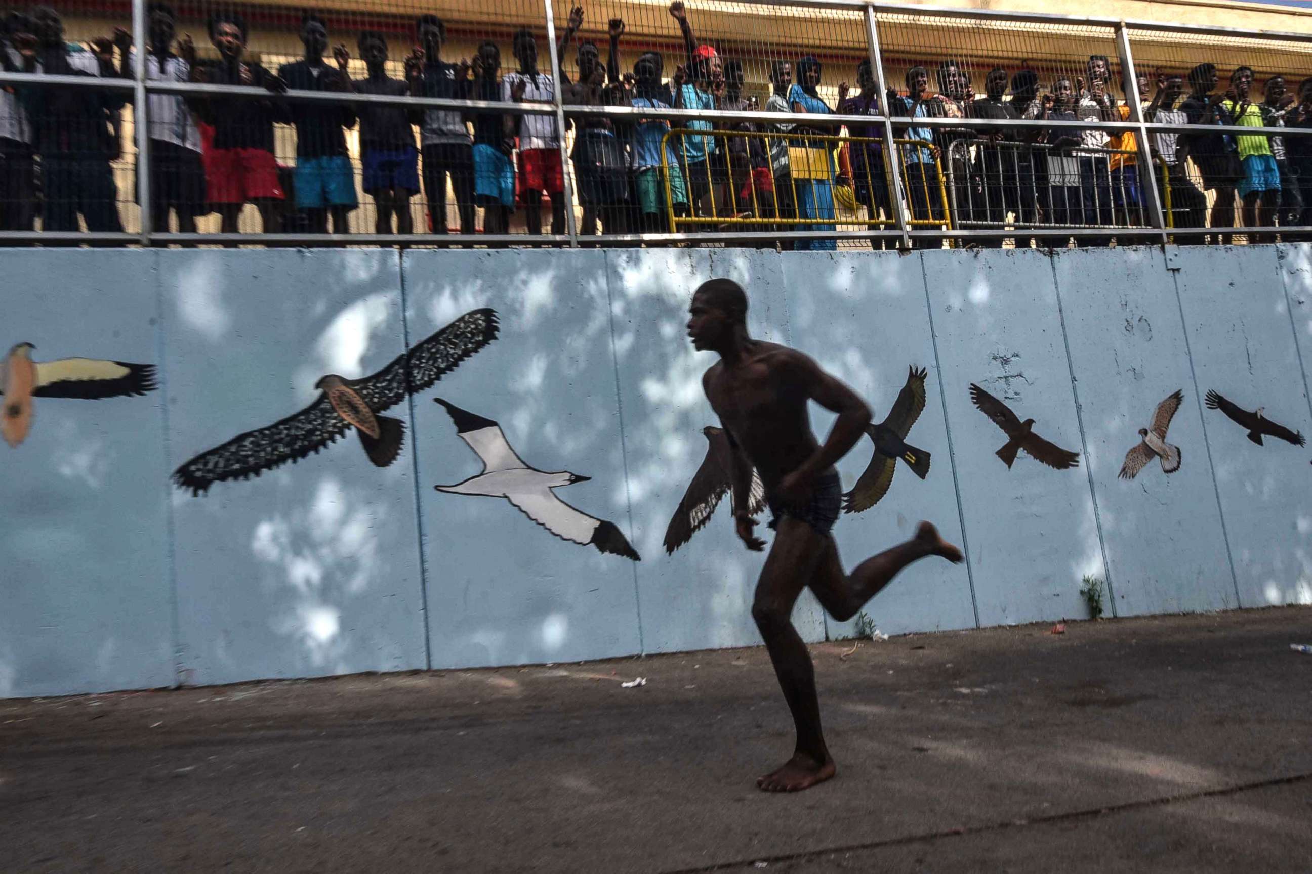 PHOTO: A man runs after over 100 migrants forced their way into the Spanish territory of Ceuta on Aug. 22, 2018.