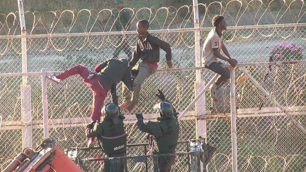 PHOTO: African migrants in this still image from video climb the border from Morocco to Spain's North African enclave of Ceuta, Spain, July 26, 2018.