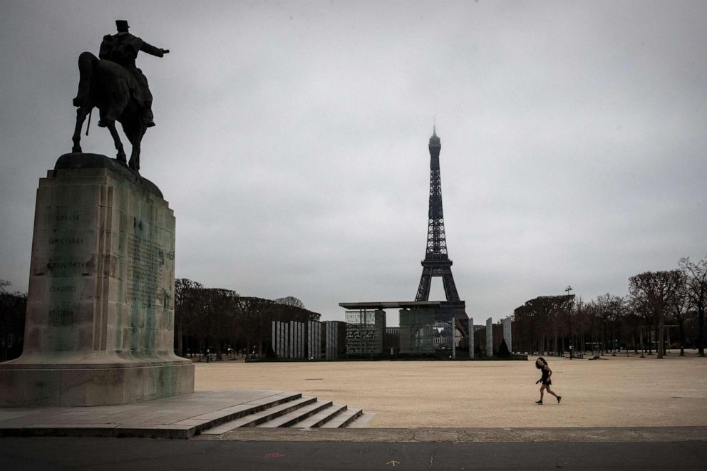 PHOTO: In this file photo taken on March 21, 2020, a jogger runs at the Champs de Mars in Paris as a strict nationwide lockdown comes into in effect in France to stop the spread of the novel coronavirus.