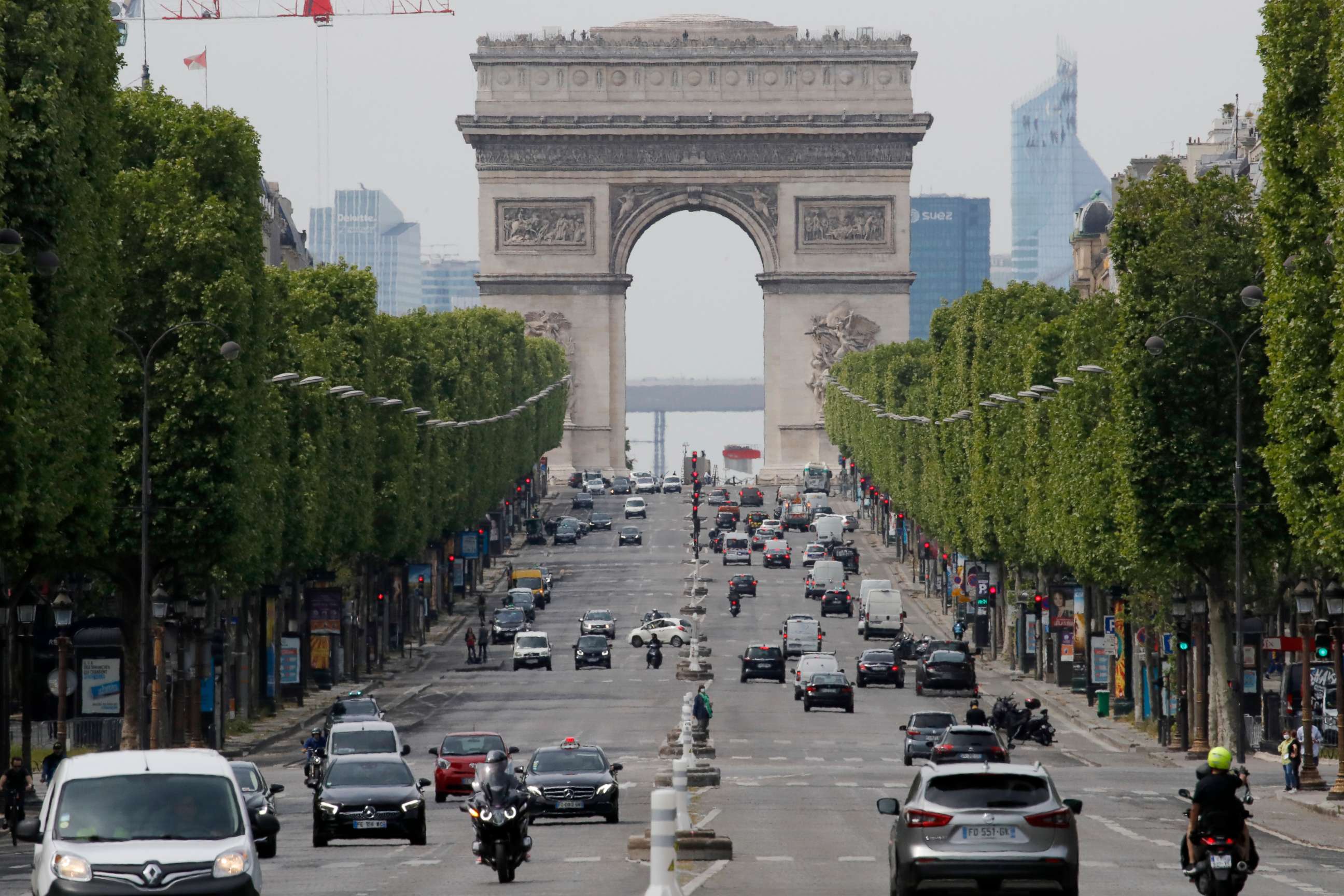 PHOTO: Cars drive on the Champs Elysee avenue, with a view of the Arc de Triomphe in the background, in Paris, France, on May 7, 2020.