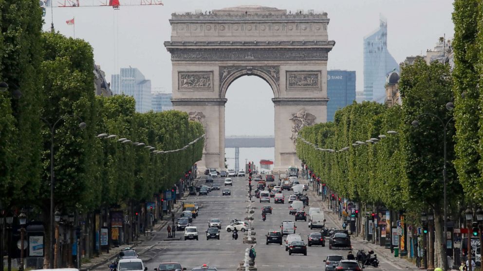 PHOTO: Cars drive on the Champs Elysee avenue, with a view of the Arc de Triomphe in the background, in Paris, France, on May 7, 2020.