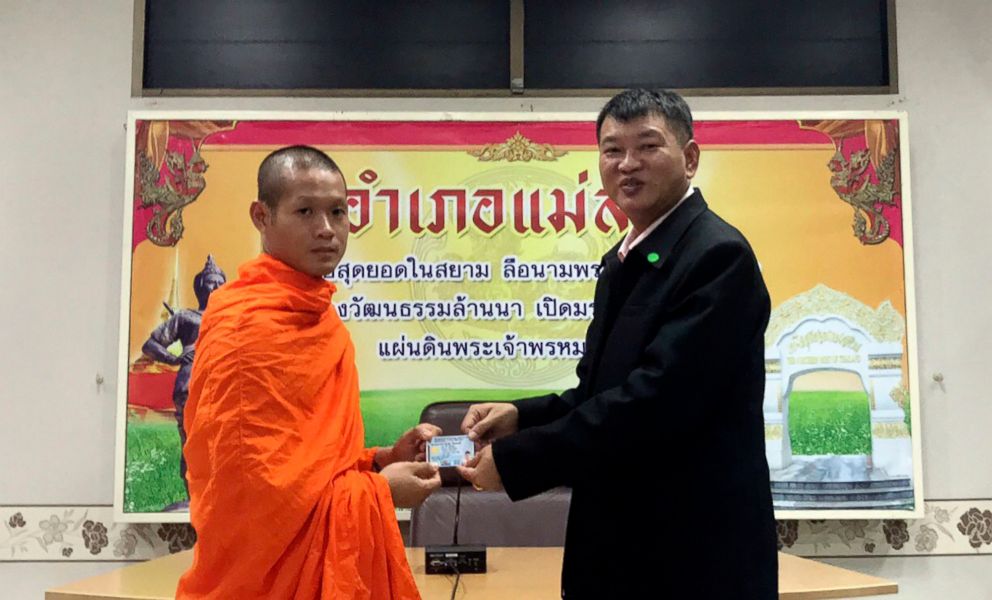 PHOTO: Former soccer coach Ekkapol Chantawong, left, receives an identity card denoting Thai citizenship from Somsak Kunkam, Sheriff of Mae Sai during a ceremony in Chiang Rai province, Thailand, Aug. 8, 2018.