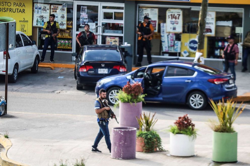 PHOTO: Cartel gunmen are seen outside during clashes with federal forces following the detention of Ovidio Guzman, son of drug kingpin Joaquin "El Chapo" Guzman, in Culiacan, Sinaloa state, Mexico, Oct. 17, 2019.