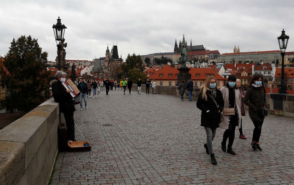 PHOTO: People walk across the medieval Charles Bridge in Prague, Czech Republic, on Oct. 11, 2020.