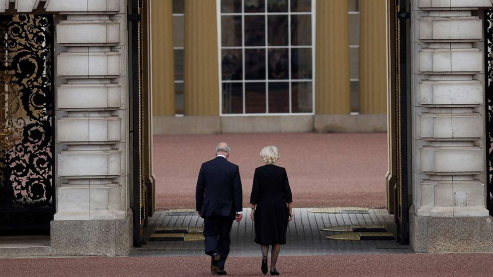 PHOTO: King Charles and Camilla, Queen Consort walk into Buckingham Palace, following the passing of Queen Elizabeth, in London, Sept 9, 2022.