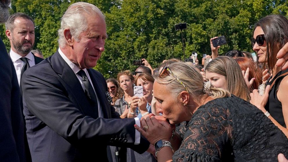 PHOTO: A well-wisher kisses the hand of Britain's King Charles III as he walks outside at Buckingham Palace following Thursday's death of Queen Elizabeth II, in London, Sept. 9, 2022.