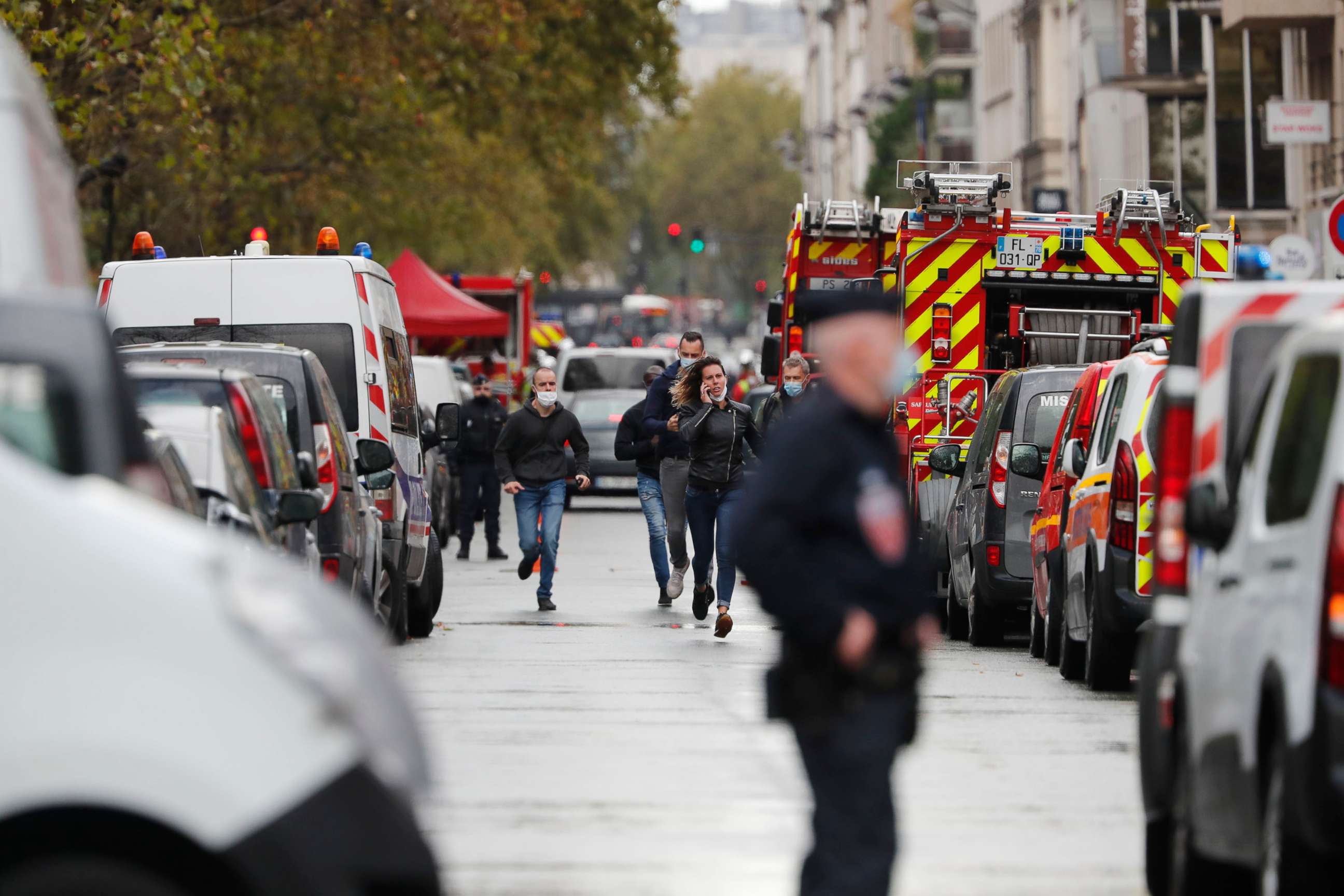PHOTO: Police run in the area where two people were attacked with a knife near the former offices of the satirical newspaper Charlie Hebdo in Paris, Sept. 25, 2020.   