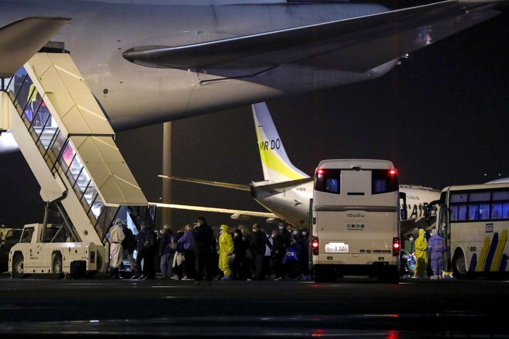 PHOTO: Passengers of the Diamond Princess cruise ship, where a number of people have tested positive for the novel coronavirus, board their charter flight at Haneda Airport in Tokyo, Japan, Feb. 17, 2020.