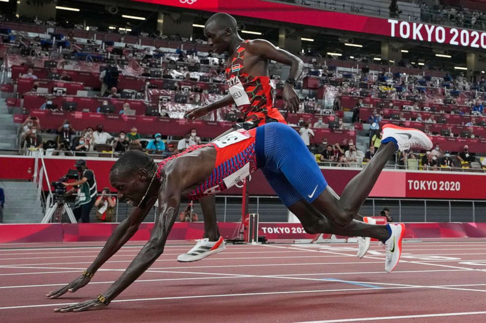 PHOTO: Paul Chelimo, of the United States, falls as he crosses the finish line in the final of the men's 5,000-meters at the 2020 Summer Olympics, Aug. 6, 2021, in Tokyo.
