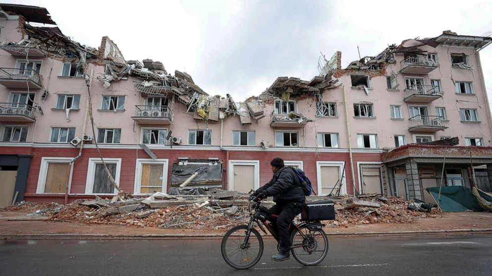 PHOTO: A local man rides a bicycle past a destroyed hotel in Chernihiv, Ukraine, April 6, 2022.